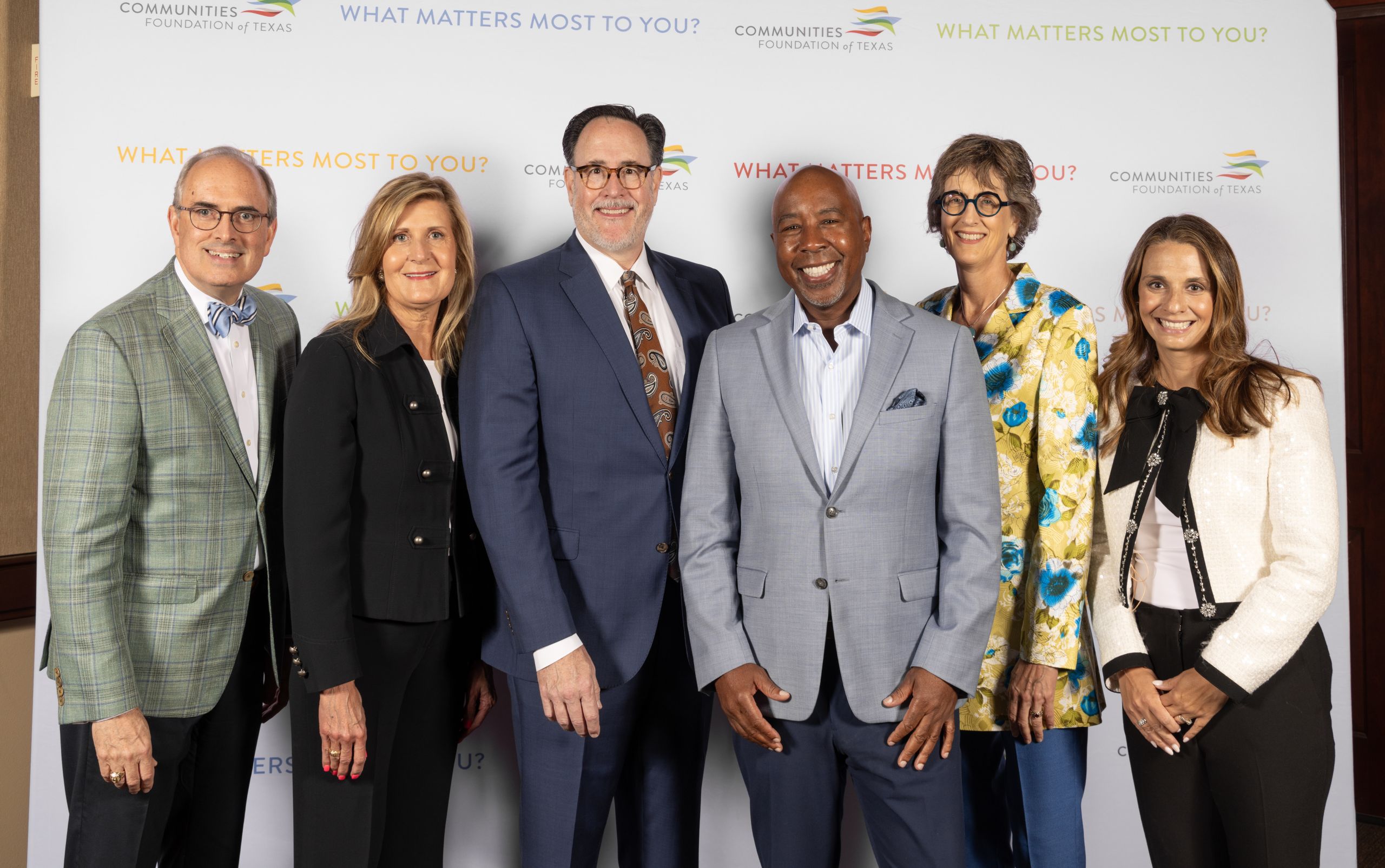 Group photo of people in front of step & repeat
