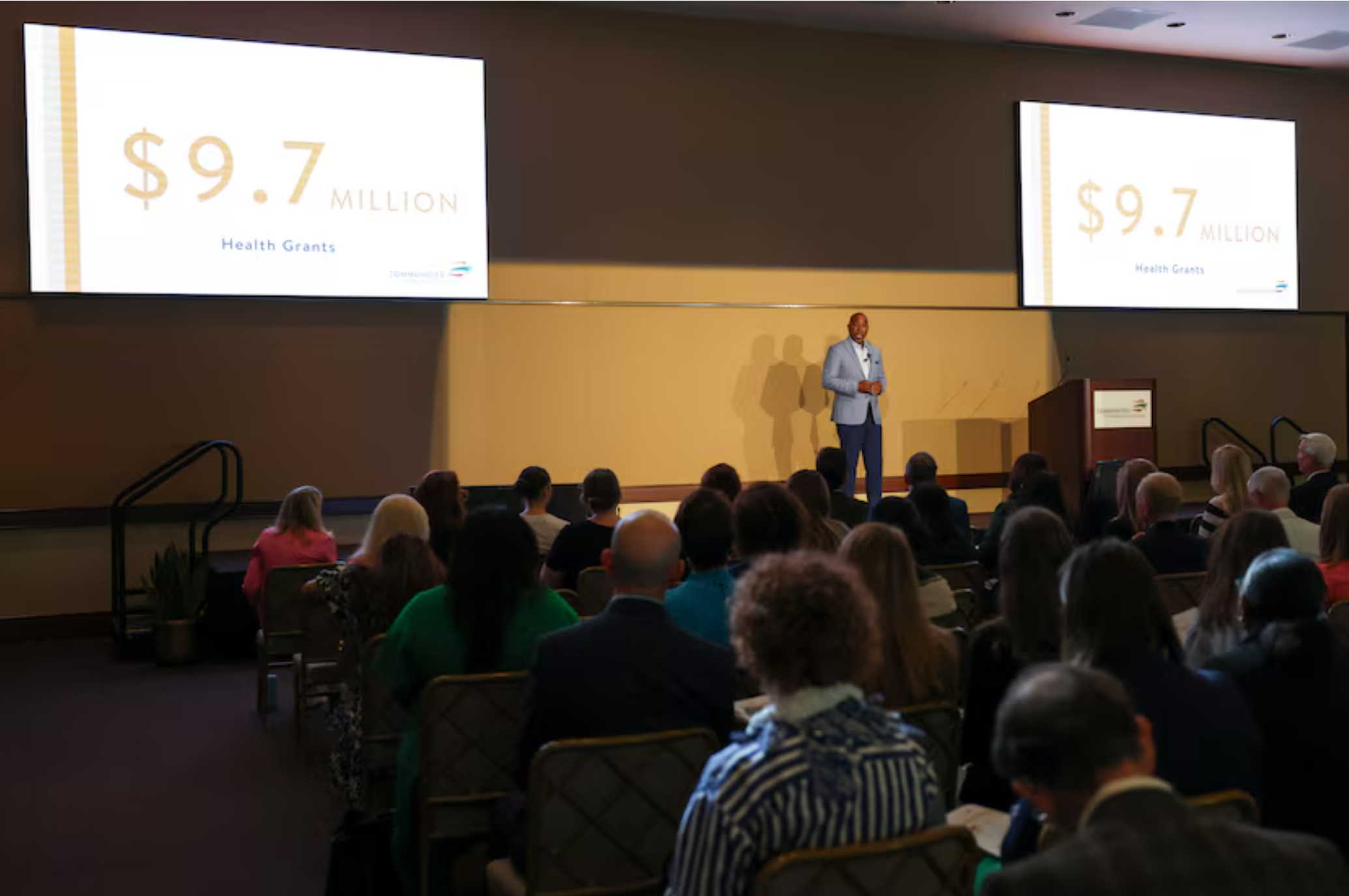 Man at event speaking on stage