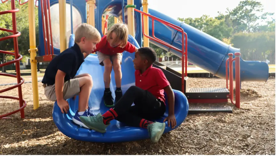Kids on playground spinning wheel