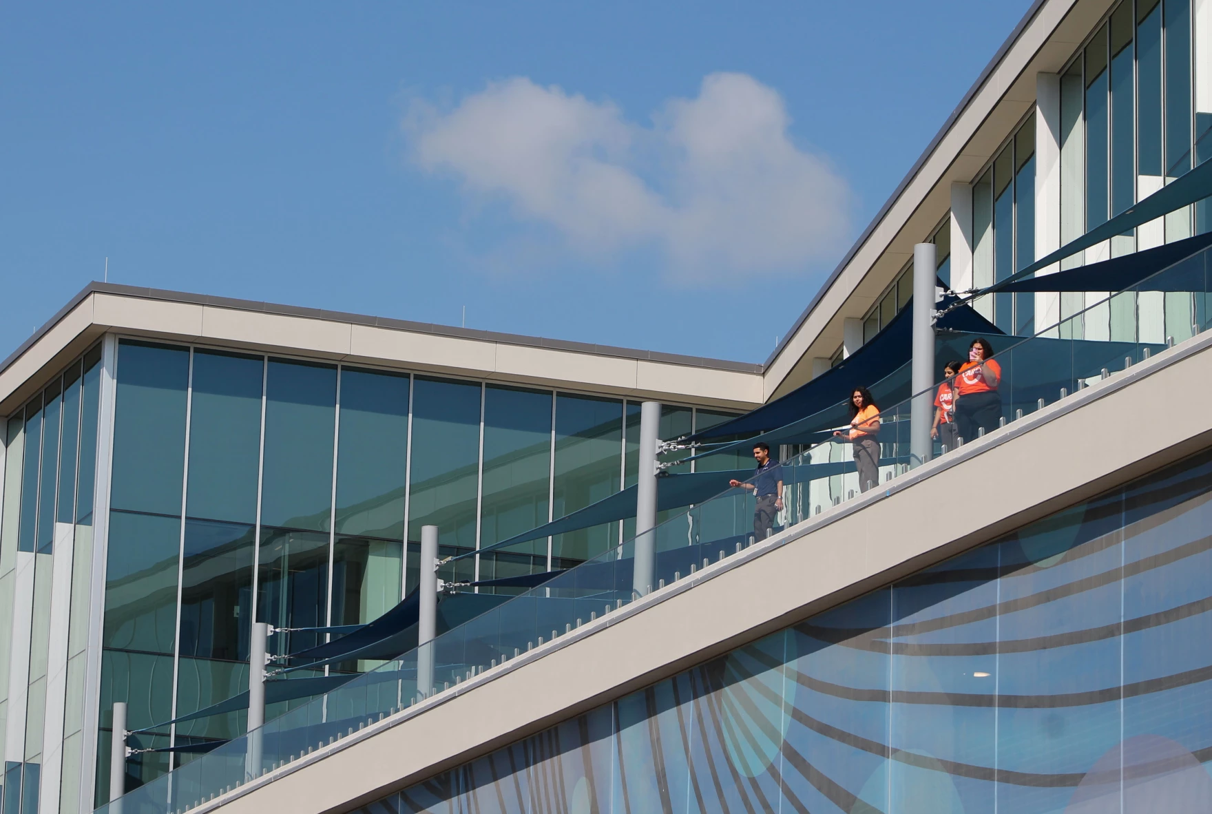 Metrocare staff and volunteers look out over the new Mental Health and Disability Innovation Center campus from the client services building after the ribbon cutting ceremony. The campus is expected to open in about a month.