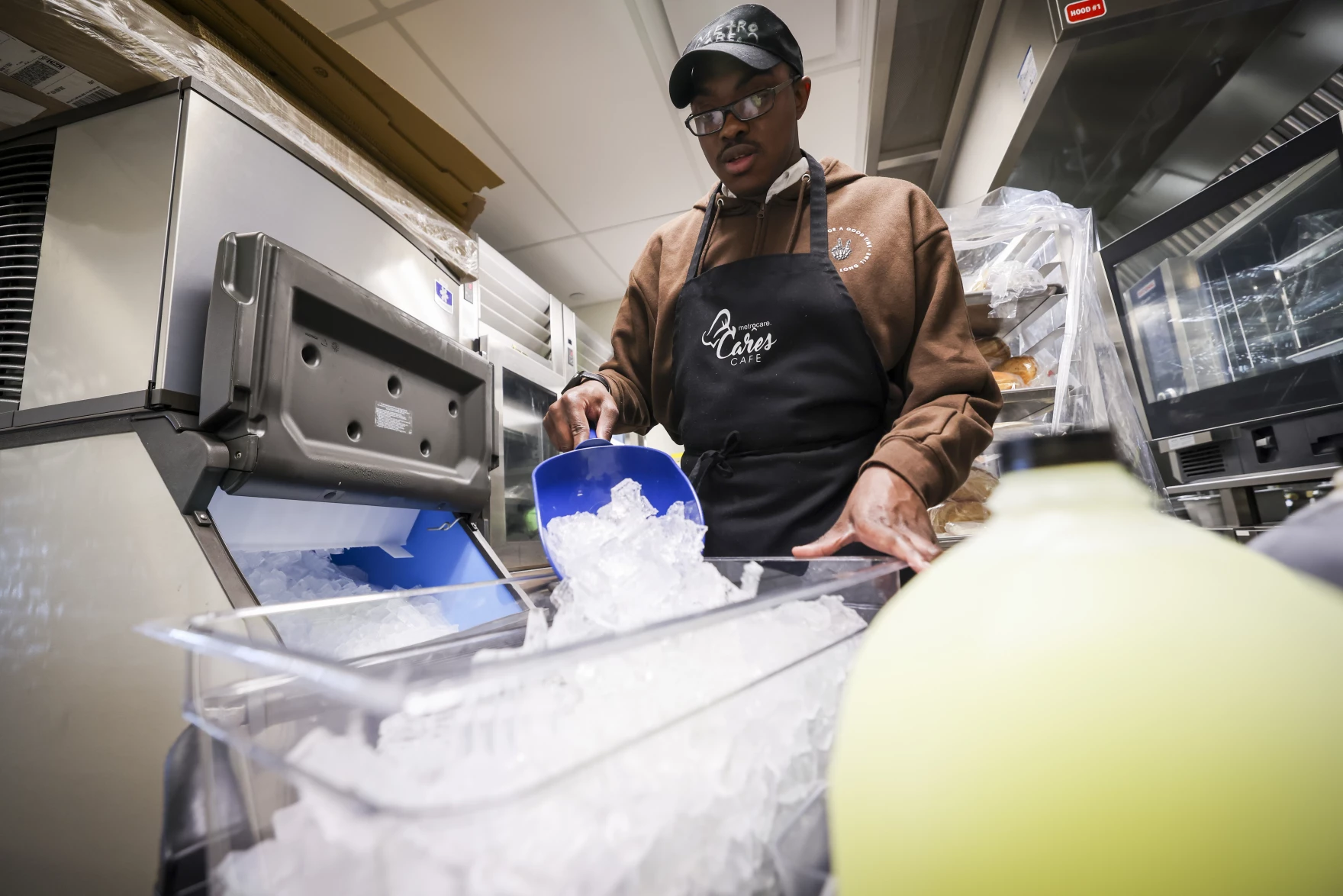 Intern James Dunn gets ice ready for catering Monday, March 2, 2026, at Metrocare’s Cares Cafe in Dallas