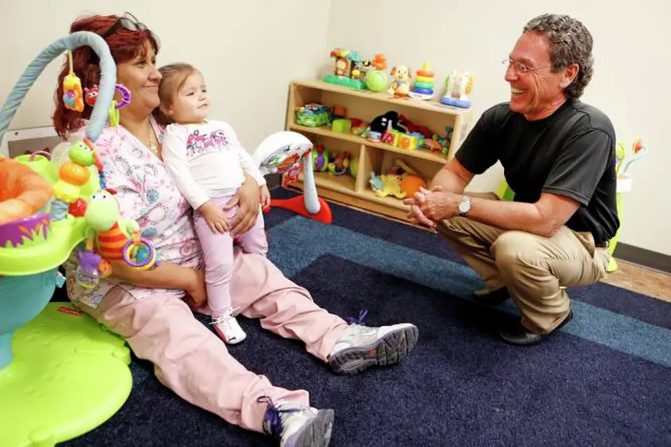 Benjamin Scott Allen met 15-month-old Aly Coronado and teacher Sonia Hurtado at Bryan’s House, which is named after Allen’s son who died of AIDS.