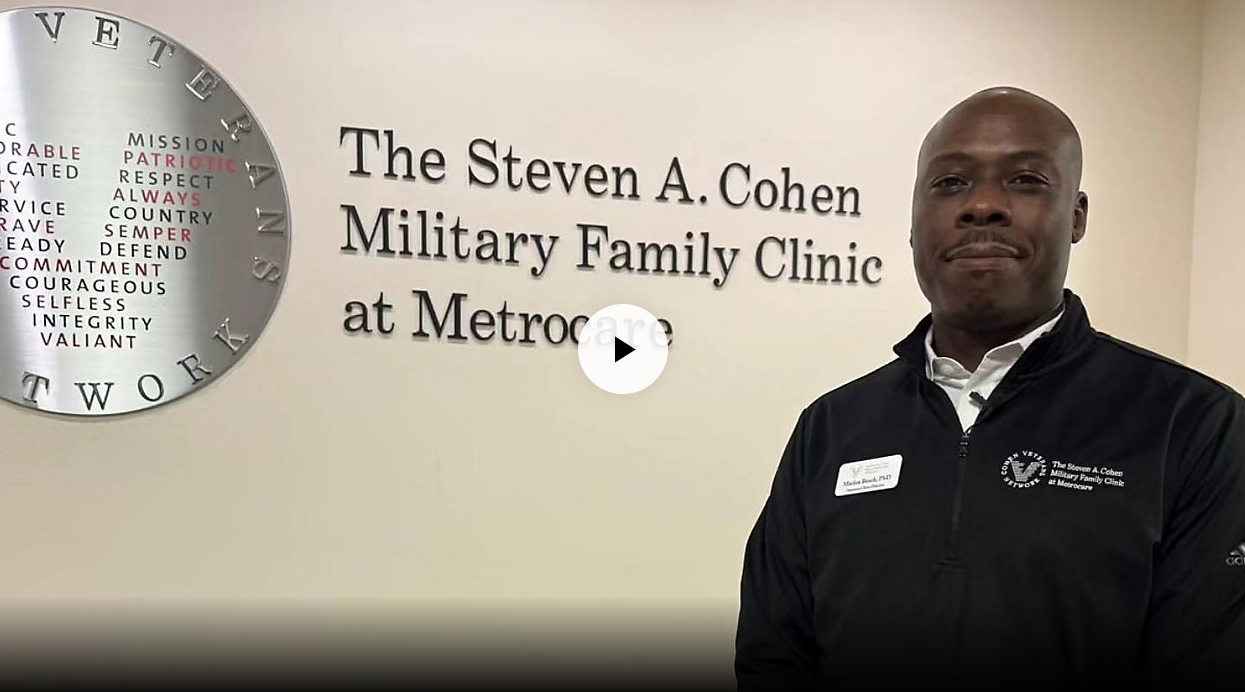 In The News 3 Dr. Marlon Beach stands in front of The Steven A. Cohen Military Family Clinic sign. (Spectrum News 1/Blessing Iwuchukwu)